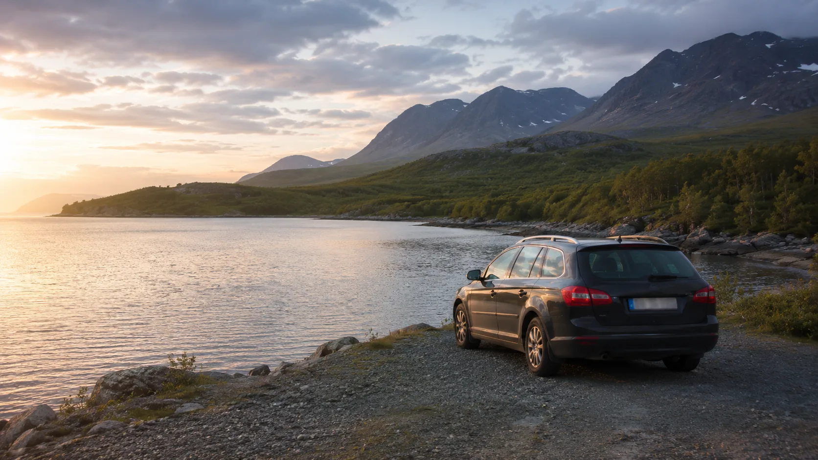 A car beside mountains and water during a Norrbotten road trip